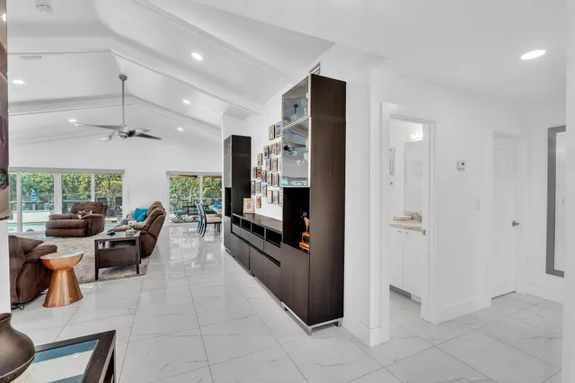 a kitchen with stainless steel appliances granite countertop white cabinets a stove top oven and a sink