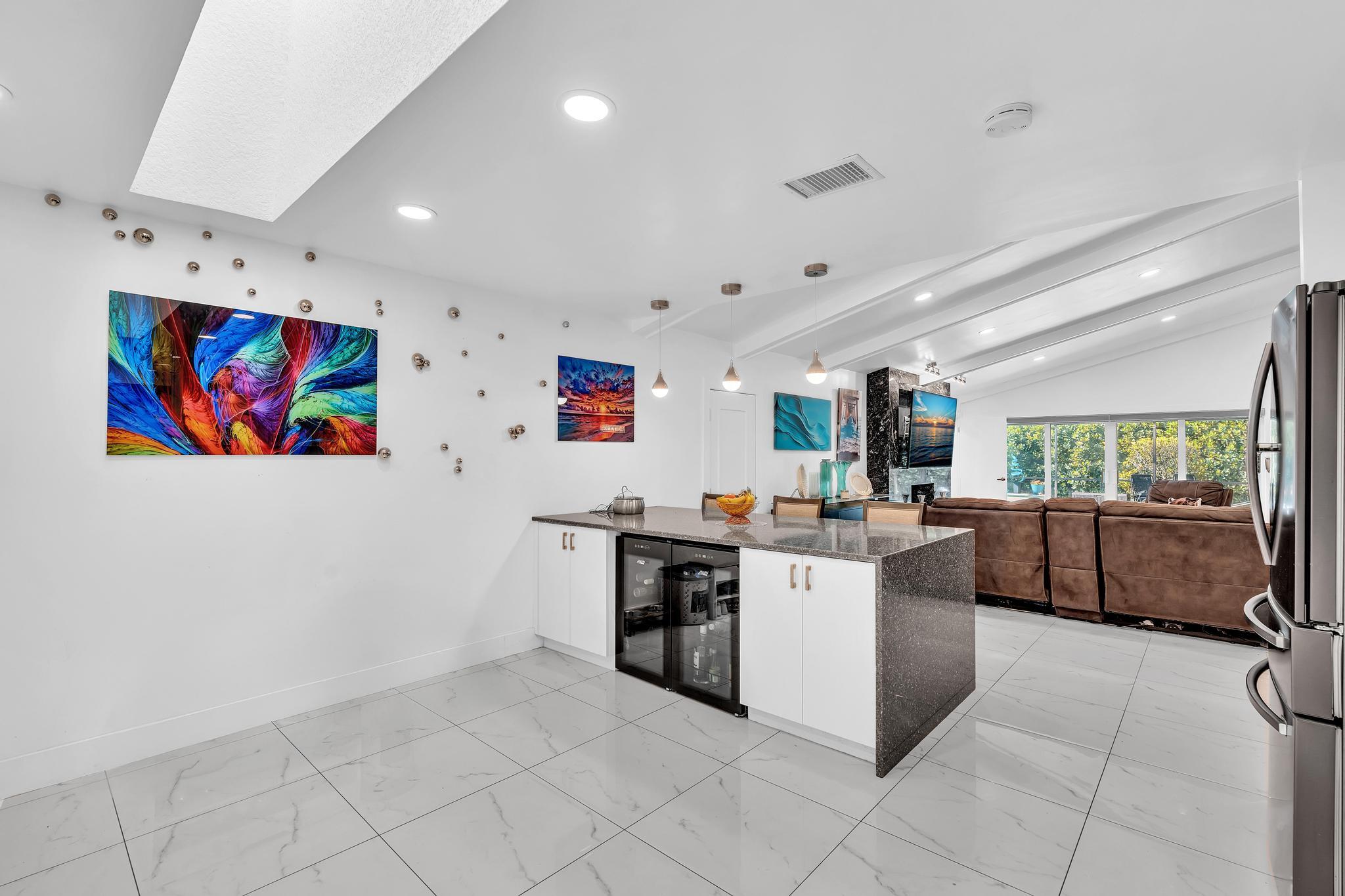 20104 Back 9 Drive Boca Raton, FL 33498 - Photo 16 of 78 a kitchen with stainless steel appliances a stove a refrigerator a sink dishwasher and white cabinets with wooden floor