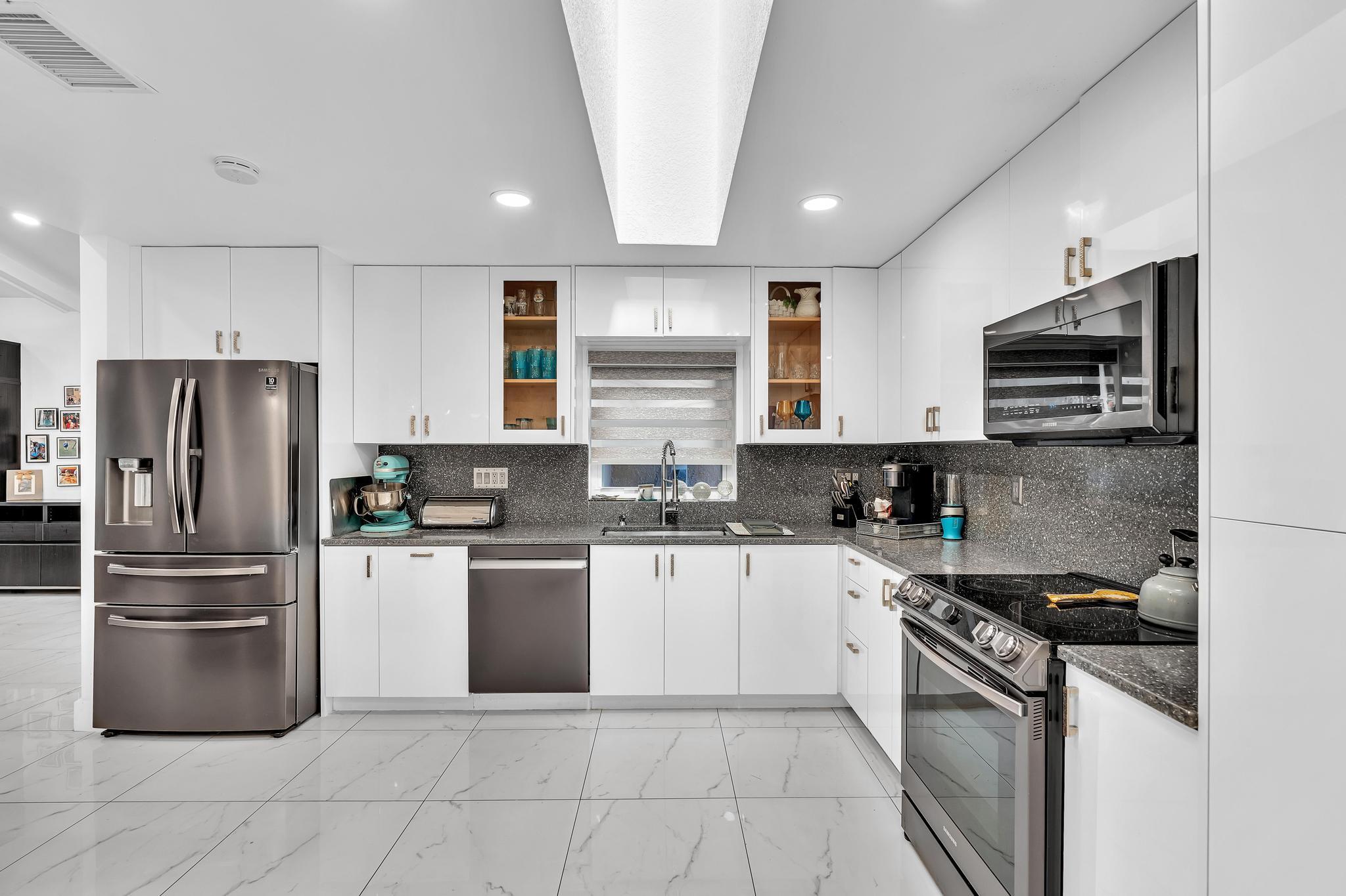20104 Back 9 Drive Boca Raton, FL 33498 - Photo 19 of 78 a kitchen with stainless steel appliances granite countertop a refrigerator sink and stove