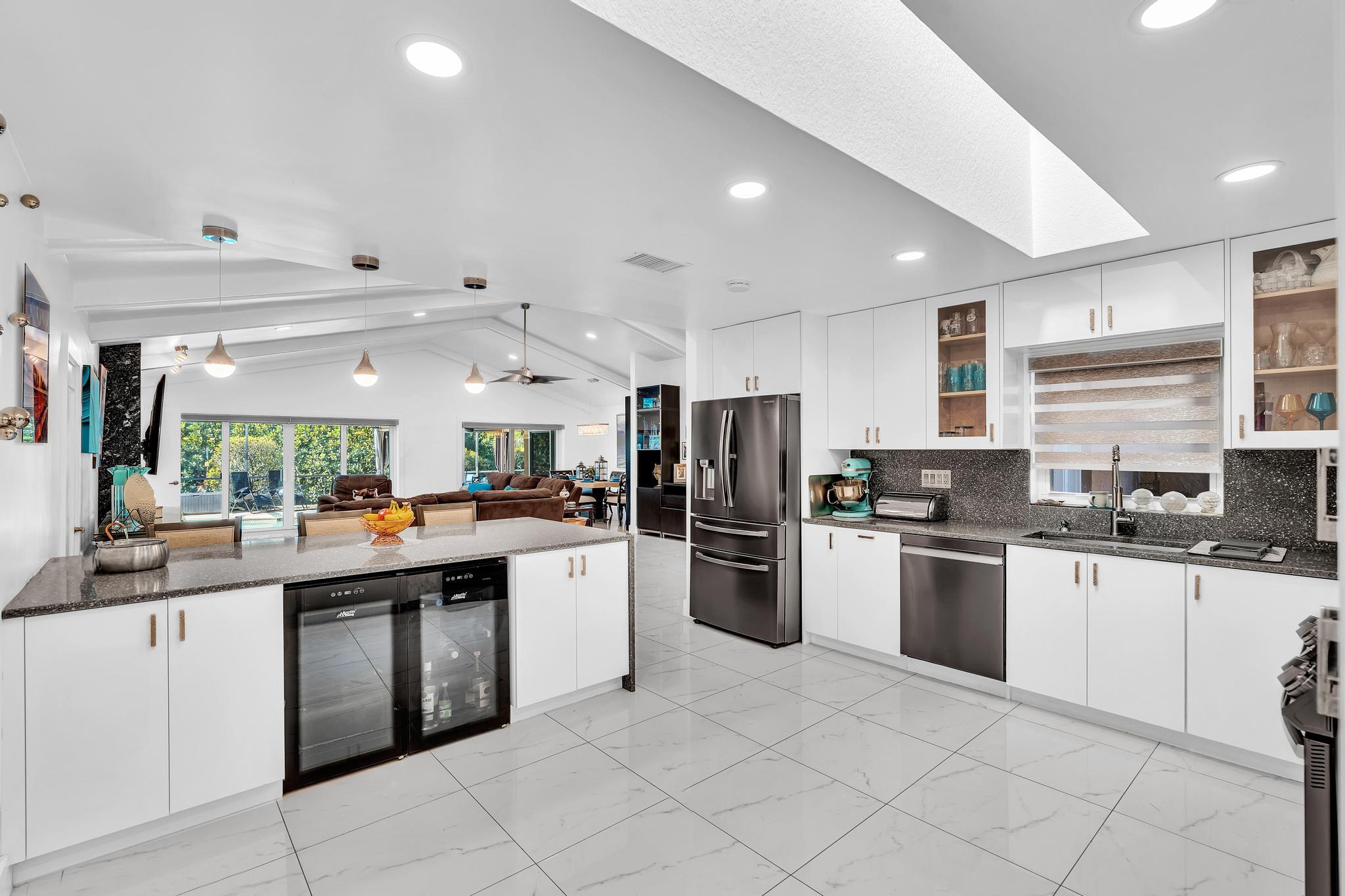 20104 Back 9 Drive Boca Raton, FL 33498 - Photo 20 of 78 a kitchen with stainless steel appliances and white cabinets