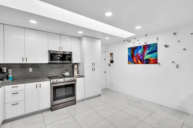 a bathroom with a shower sink and mirror