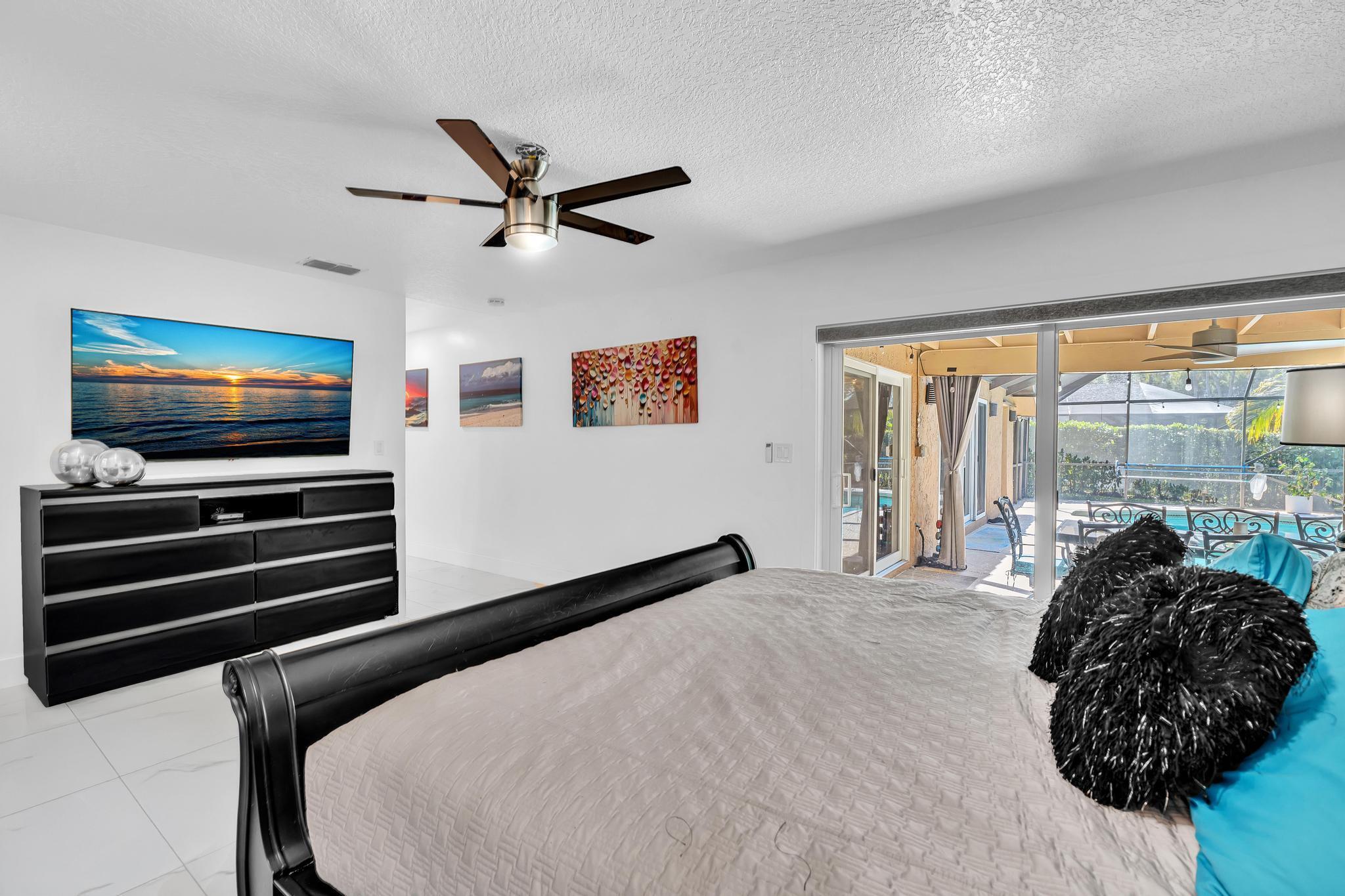 20104 Back 9 Drive Boca Raton, FL 33498 - Photo 29 of 78 a bedroom with a bed and a flat tv screen