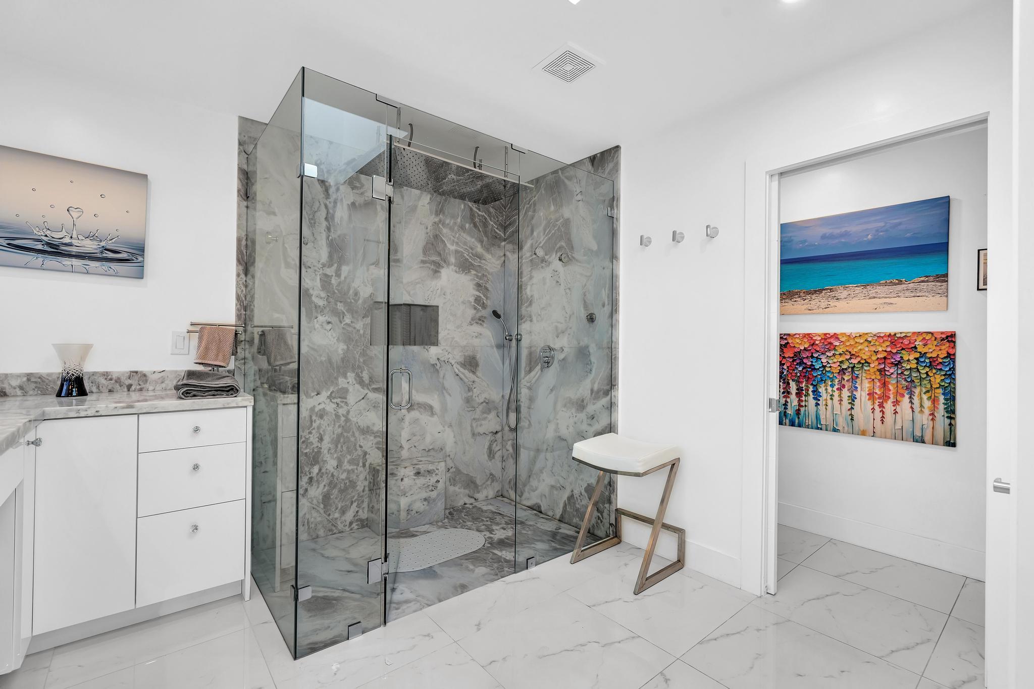 20104 Back 9 Drive Boca Raton, FL 33498 - Photo 33 of 78 a bathroom with a shower sink and mirror