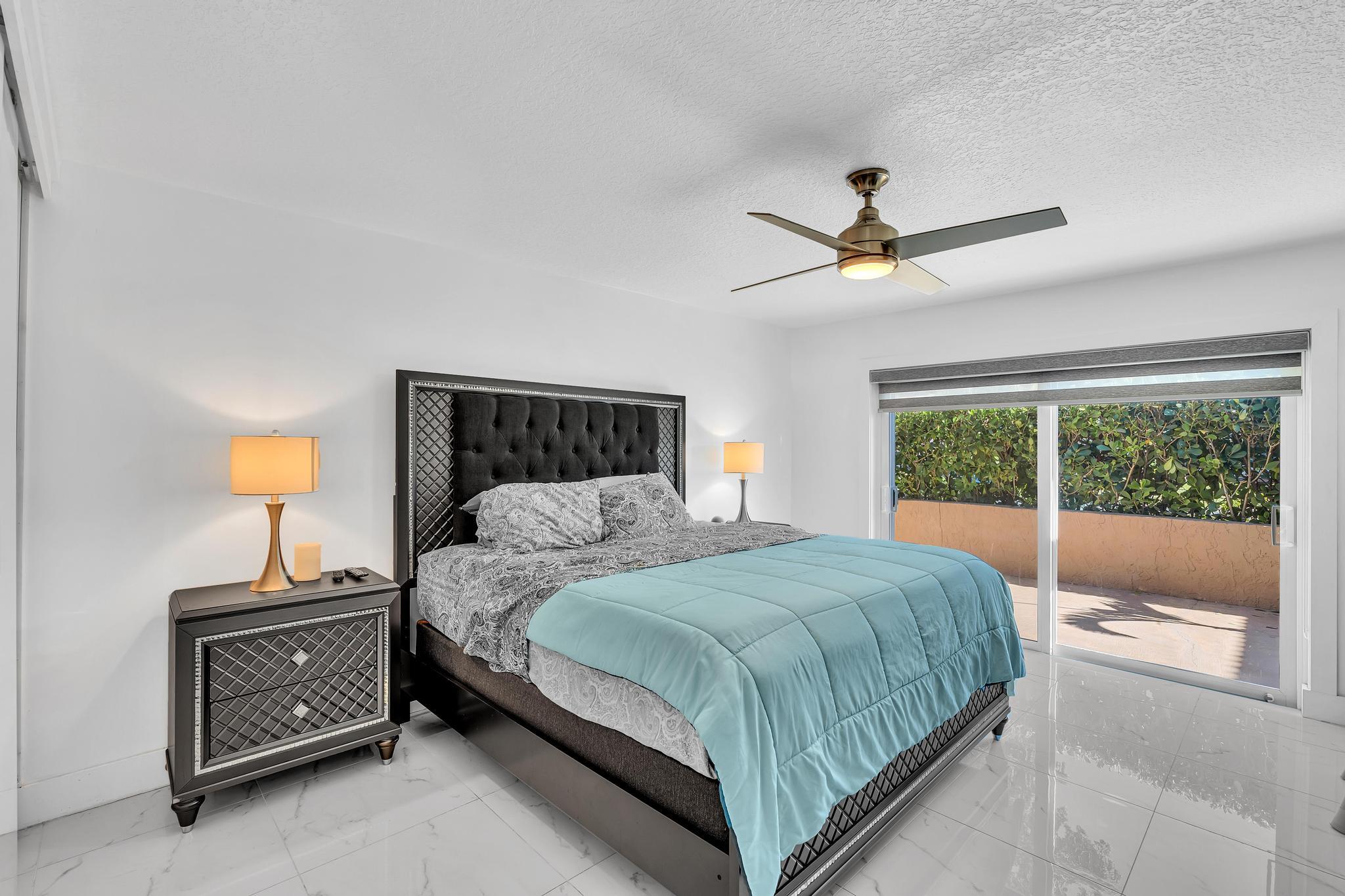 20104 Back 9 Drive Boca Raton, FL 33498 - Photo 42 of 78 a bedroom with a bed and a chandelier