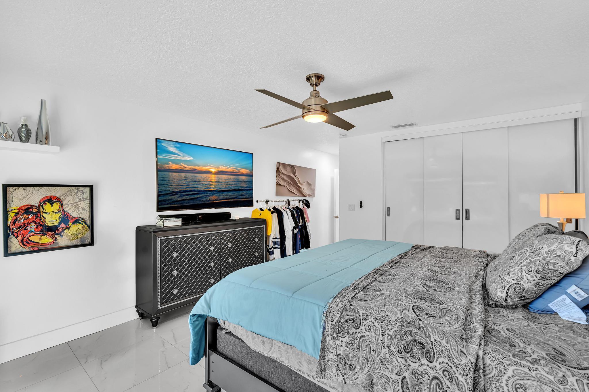 20104 Back 9 Drive Boca Raton, FL 33498 - Photo 43 of 78 a bedroom with a bed and a flat screen tv