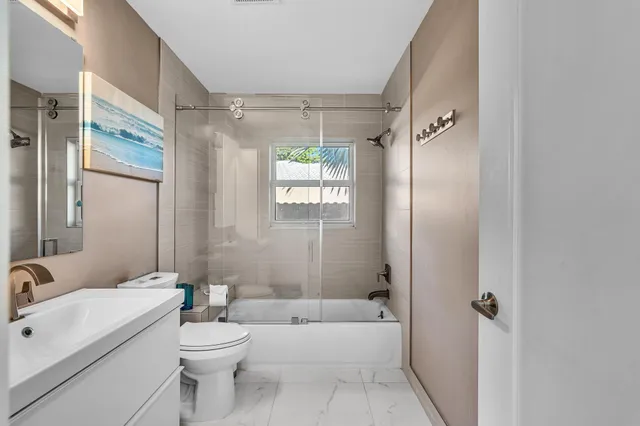 an aerial view of residential houses with outdoor space and trees