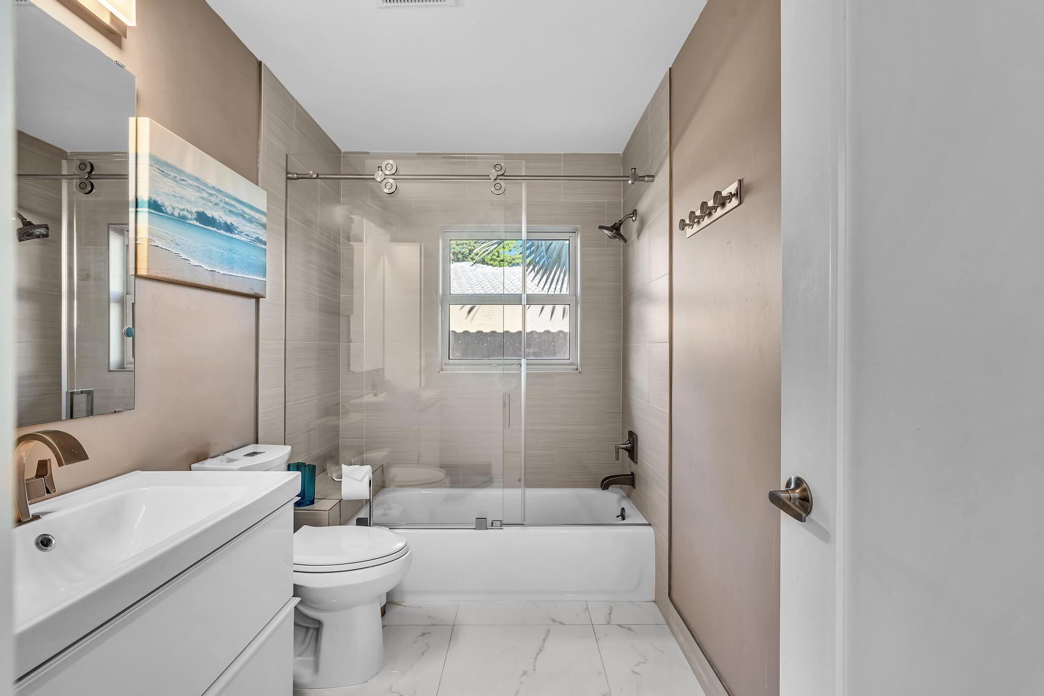 20104 Back 9 Drive Boca Raton, FL 33498 - Photo 45 of 78 a bathroom with a toilet a sink and bathtub