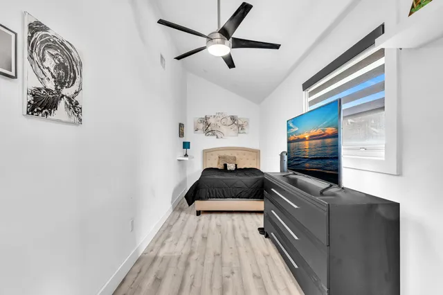 an aerial view of residential houses with outdoor space and trees