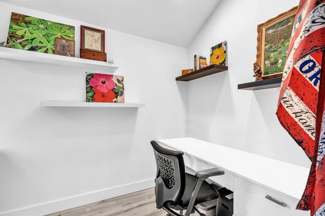 a front view of a house with a yard and potted plants