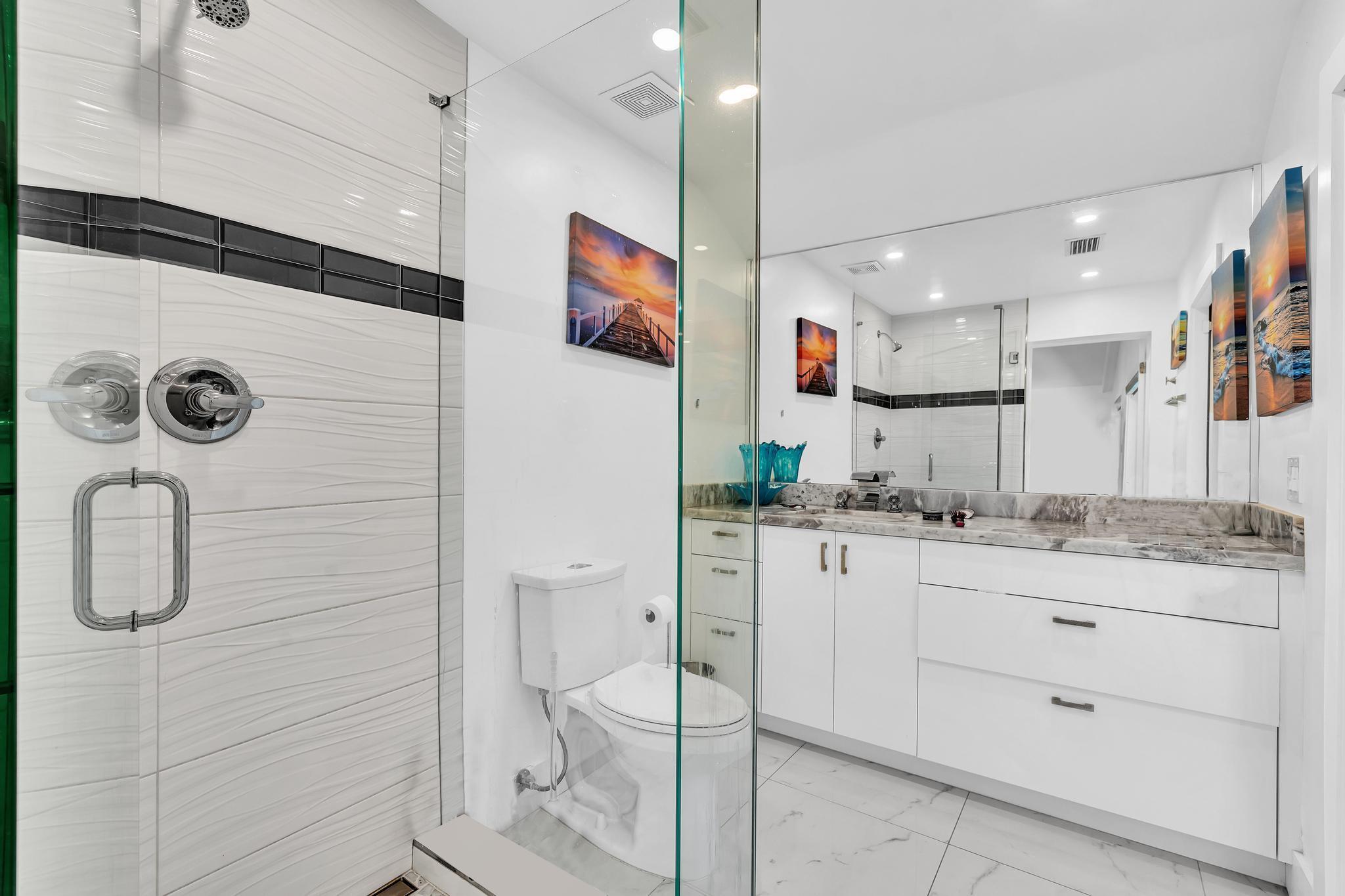 20104 Back 9 Drive Boca Raton, FL 33498 - Photo 51 of 78 a bathroom with a granite countertop sink mirror and toilet