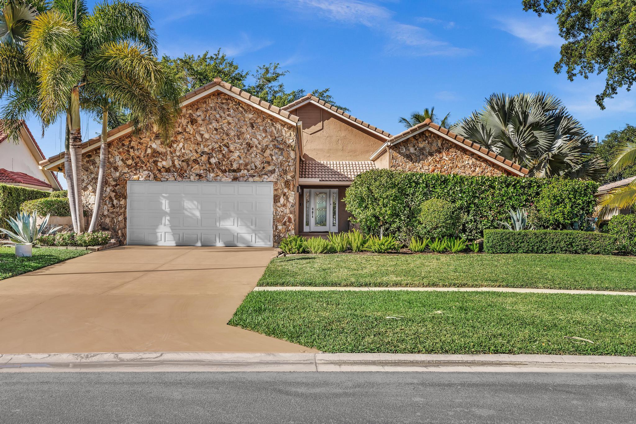 20104 Back 9 Drive Boca Raton, FL 33498 - Photo 6 of 78 front view of a house with a yard