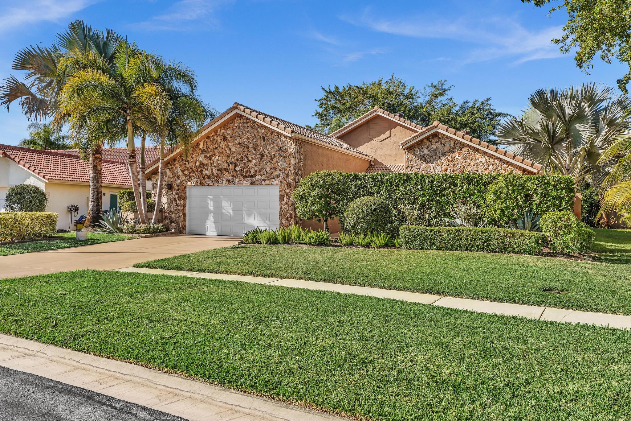 20104 Back 9 Drive Boca Raton, FL 33498 - Photo 66 of 78 a front view of house with yard and green space