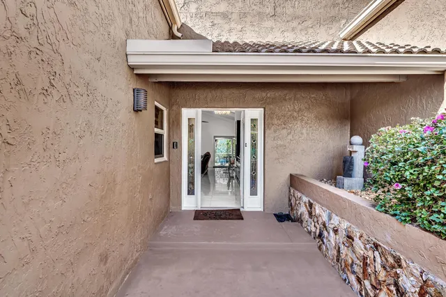 a living room with furniture kitchen view and a large window