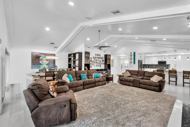 a kitchen with granite countertop white cabinets and stainless steel appliances