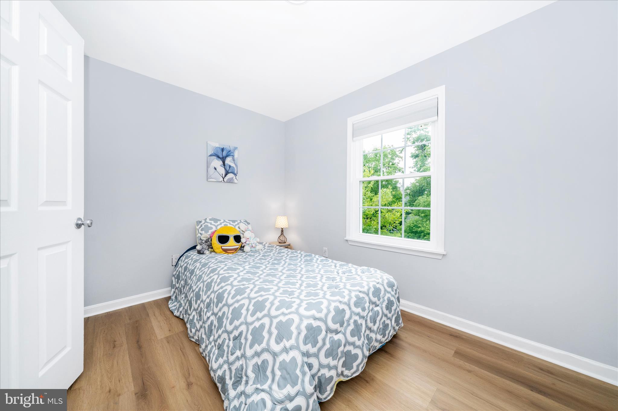 713 Seek Lane Silver Spring, MD 20912 - Photo 23 of 60 a bed sitting in a bedroom next to a window