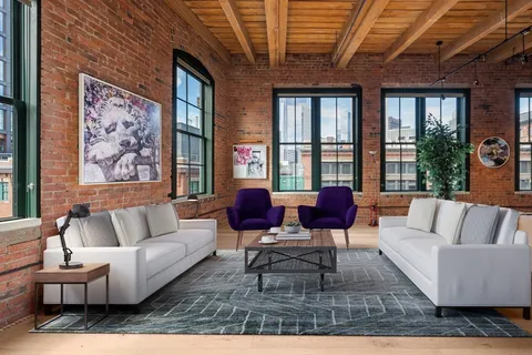 a living room with furniture wooden floor and a fireplace