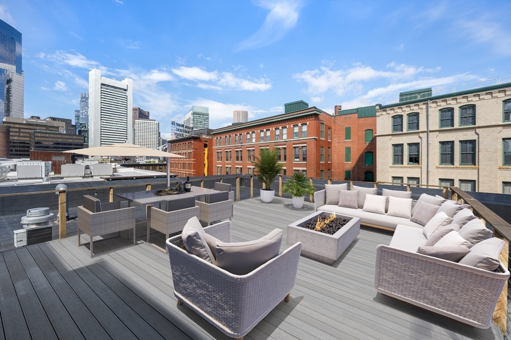 49 Melcher Street, Unit 502 Boston, MA 02210 - Photo 24 of 29 a view of a roof deck with couches and potted plants