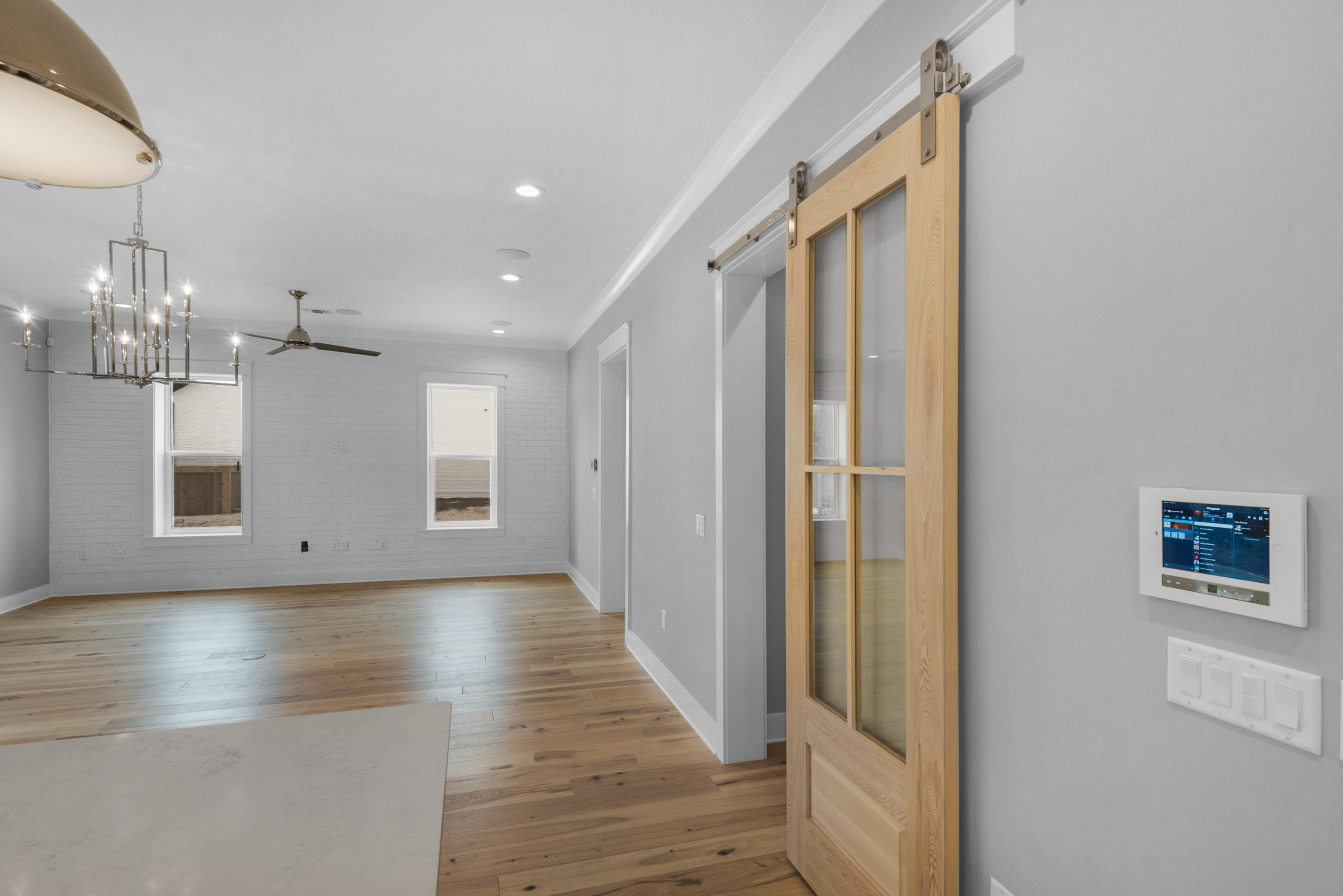 241 Ridgewalk Circle Santa Rosa Beach, FL 32459 - Photo 7 of 41 a view of a hallway with wooden floor and a large window