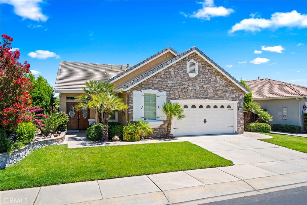 508 Casper Drive Hemet, CA 92545 - Photo 2 of 73 a front view of a house with a garden and plants