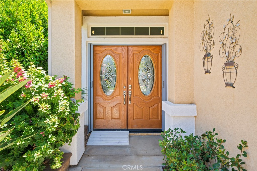 508 Casper Drive Hemet, CA 92545 - Photo 4 of 73 a sign board with flower plants in front of door
