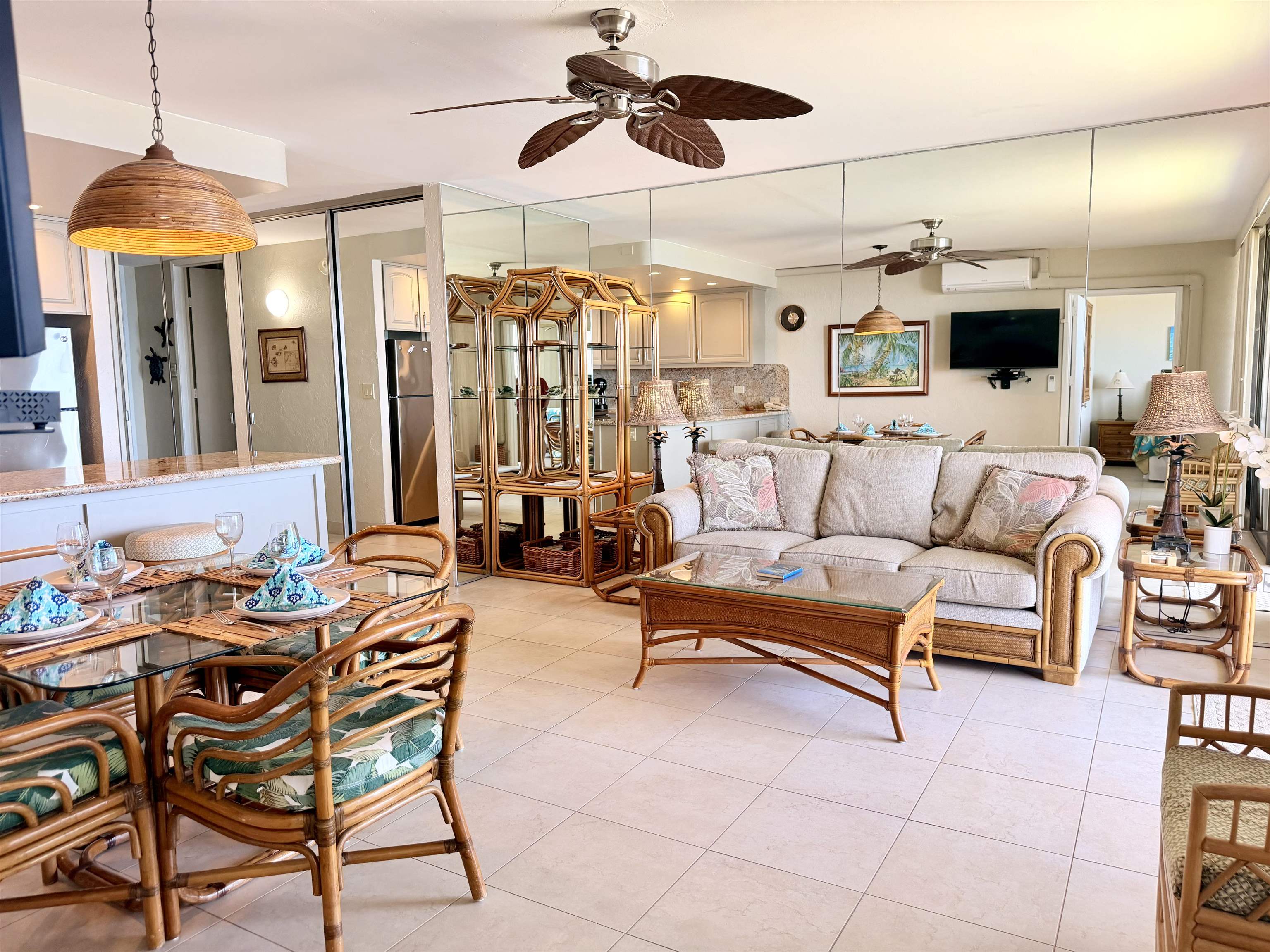3543 Lower Honoapiilani Road, Unit L302 Lahaina, HI 96761 - Photo 11 of 45 a living room with furniture a chandelier and a glass door