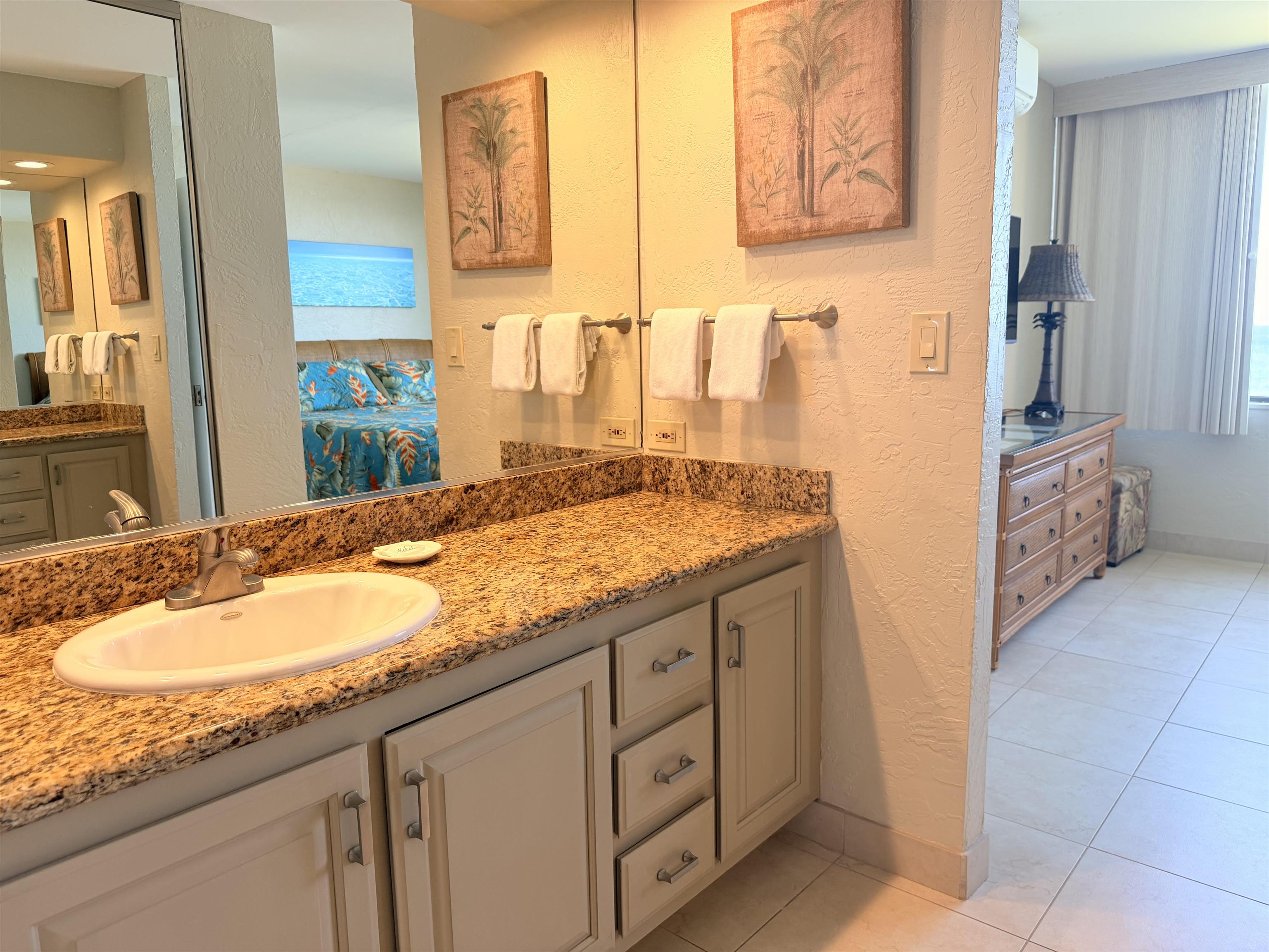 3543 Lower Honoapiilani Road, Unit L302 Lahaina, HI 96761 - Photo 21 of 45 a bathroom with a granite countertop sink and a mirror