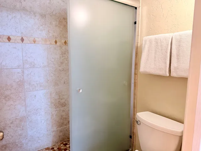 a white toilet sitting next to a bathroom sink