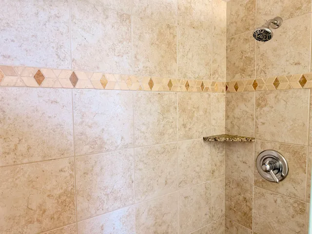 a bathroom with shower and a shower