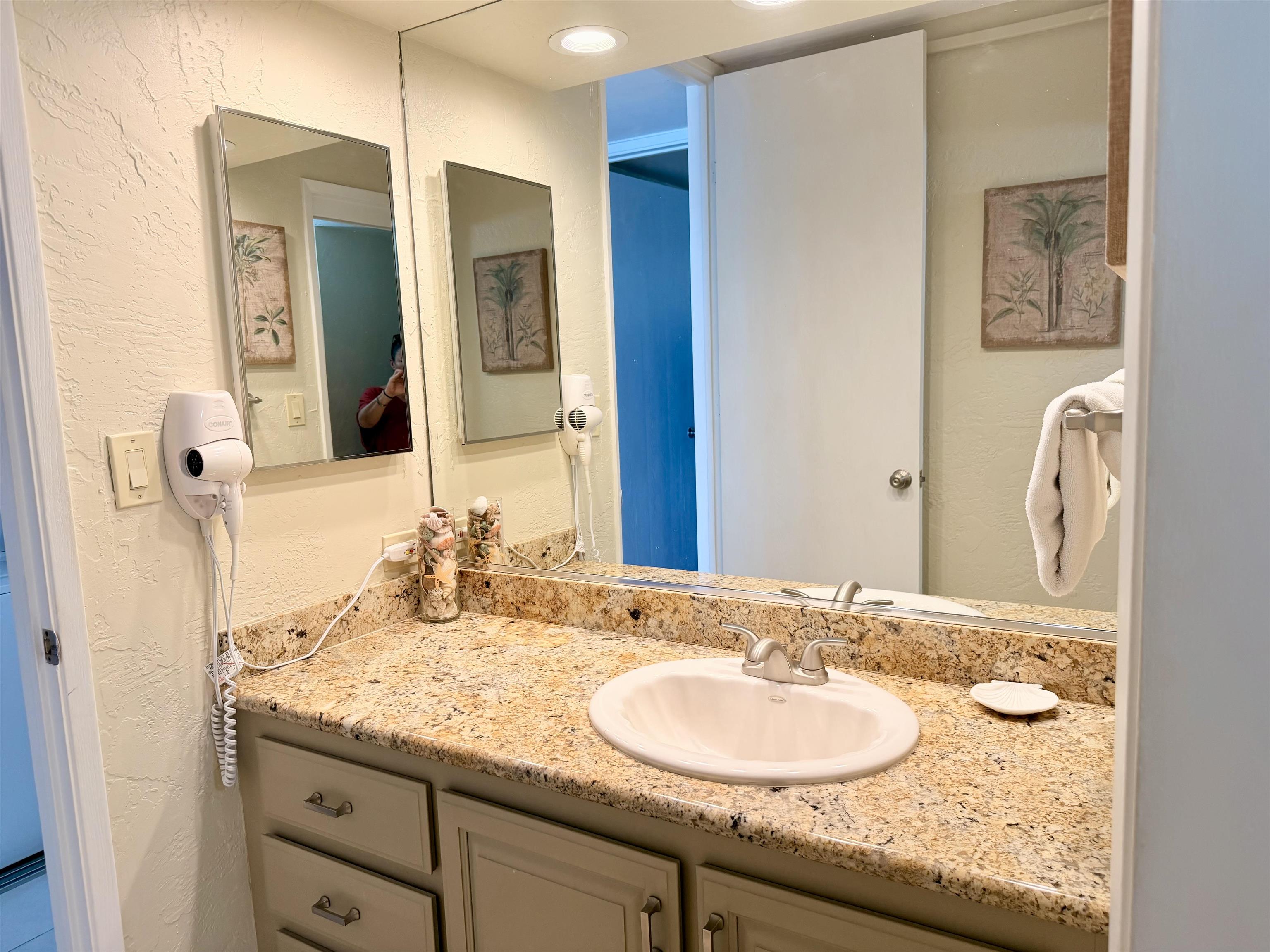 3543 Lower Honoapiilani Road, Unit L302 Lahaina, HI 96761 - Photo 28 of 45 a bathroom with a granite countertop sink and a mirror
