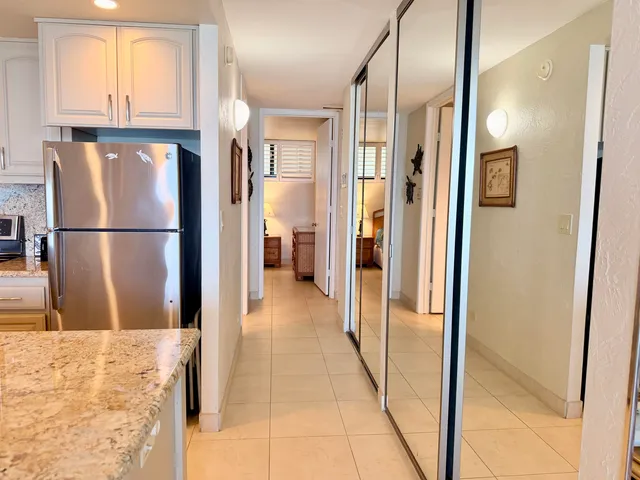 a view of a kitchen with a refrigerator and a refrigerator