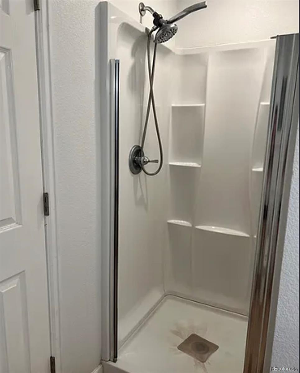 2201 South High Street, Unit 1030A Denver, CO 80210 - Photo 4 of 6 a bathroom with a glass shower door