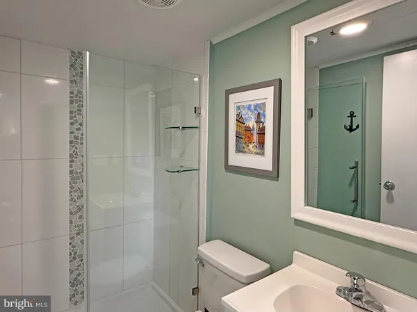 a bathroom with a toilet sink and shower