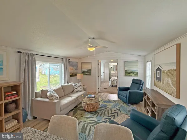 a living room with furniture large window and flat screen tv