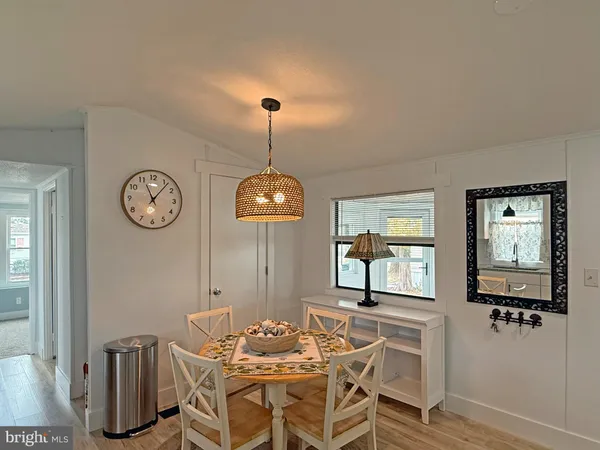 a view of a dining room with furniture and a chandelier