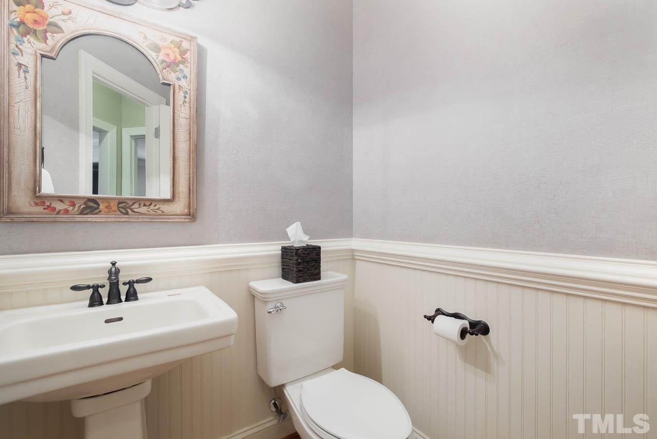 109 Nouveau Avenue Raleigh, NC 27615 - Photo 11 of 29 a bathroom with a toilet a sink and mirror