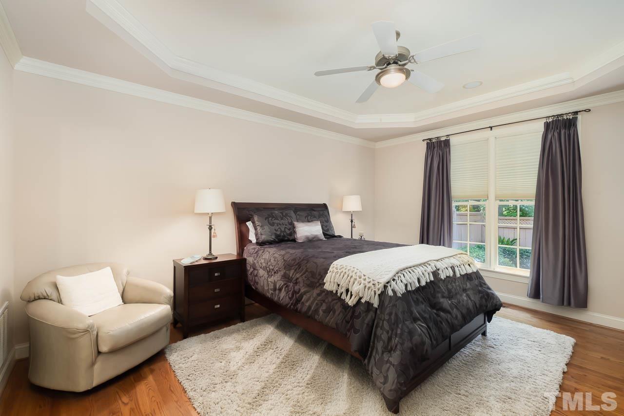 109 Nouveau Avenue Raleigh, NC 27615 - Photo 12 of 29 a bedroom with a bed and a couch