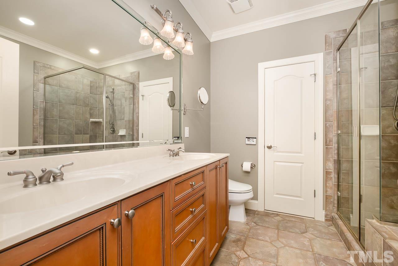 109 Nouveau Avenue Raleigh, NC 27615 - Photo 15 of 29 a bathroom with a sink a toilet a large mirror and shower