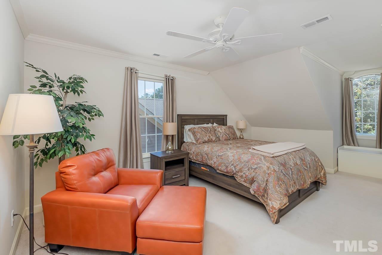 109 Nouveau Avenue Raleigh, NC 27615 - Photo 16 of 29 a bedroom with a bed and a potted plant