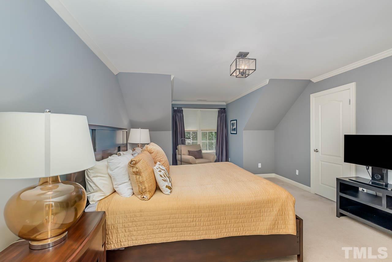 109 Nouveau Avenue Raleigh, NC 27615 - Photo 22 of 29 a bedroom with a bed and tv