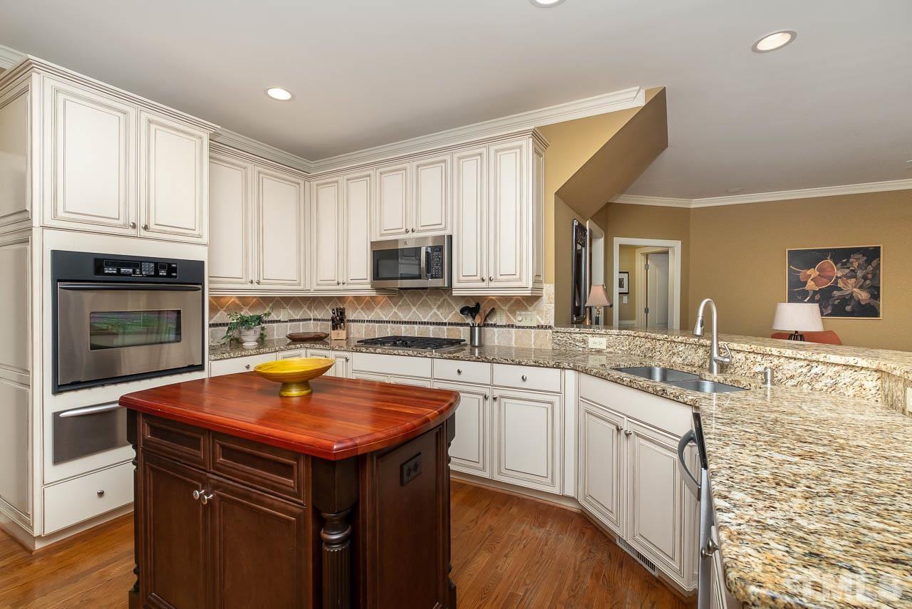 109 Nouveau Avenue Raleigh, NC 27615 - Photo 3 of 29 a kitchen with stainless steel appliances a sink dishwasher stove refrigerator and microwave