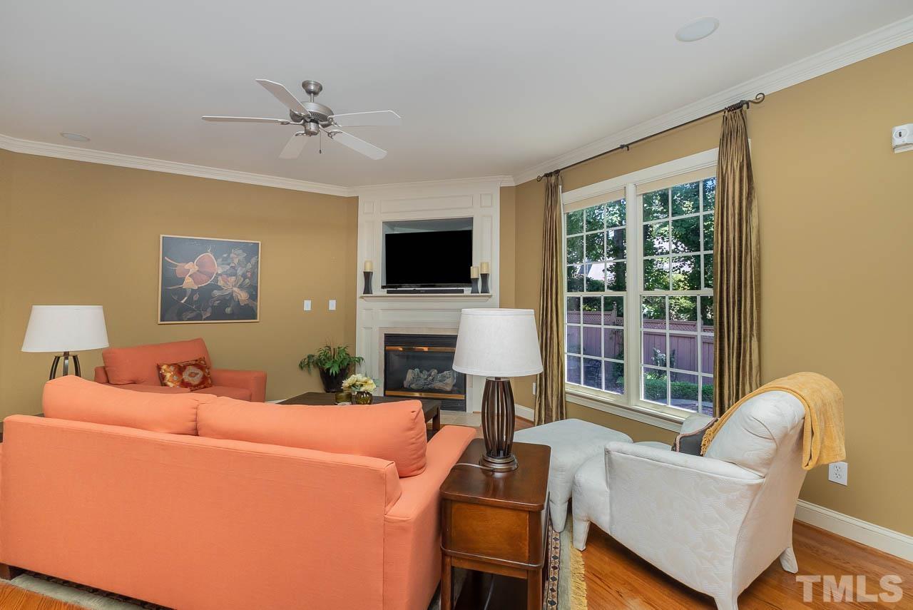 109 Nouveau Avenue Raleigh, NC 27615 - Photo 6 of 29 a living room with furniture a flat screen tv and a window