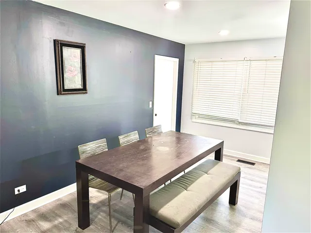 a view of a room that has a table and chairs in it