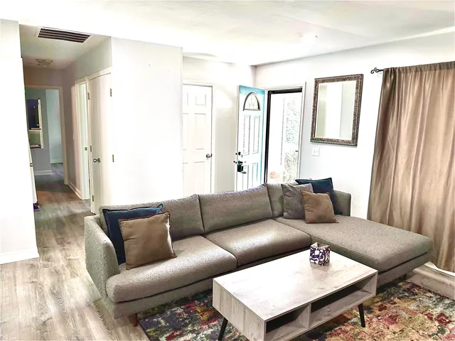 a living room with furniture and a window