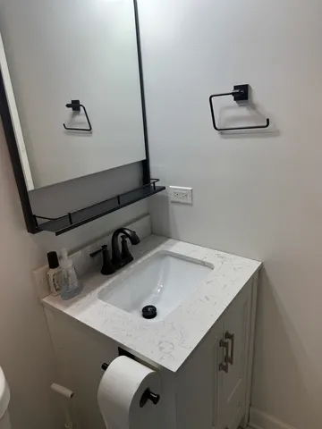 a bathroom with a sink and mirror