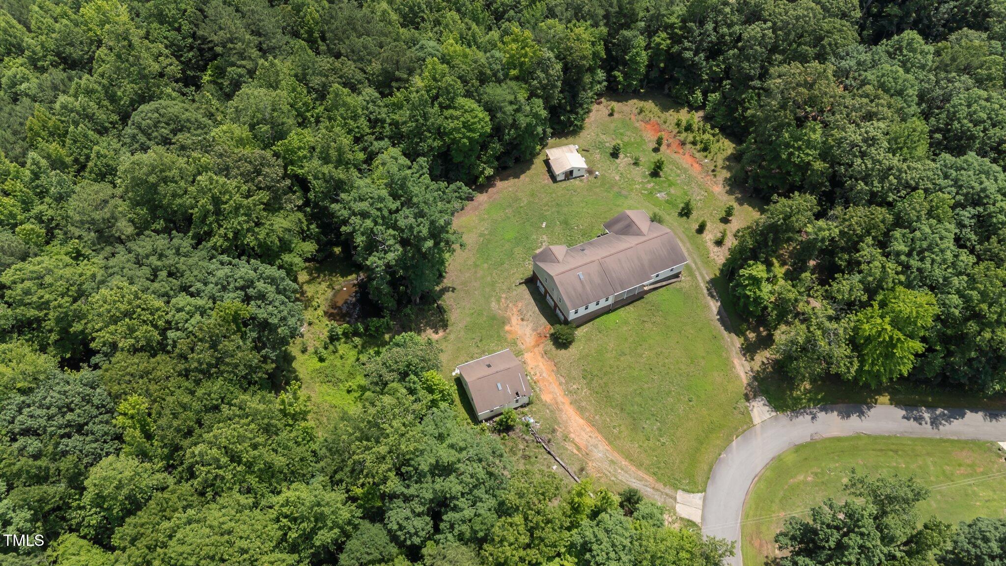 129 Shaman Drive Spring Hope, NC 27882 - Photo 13 of 33 an aerial view of a house with a garden and trees