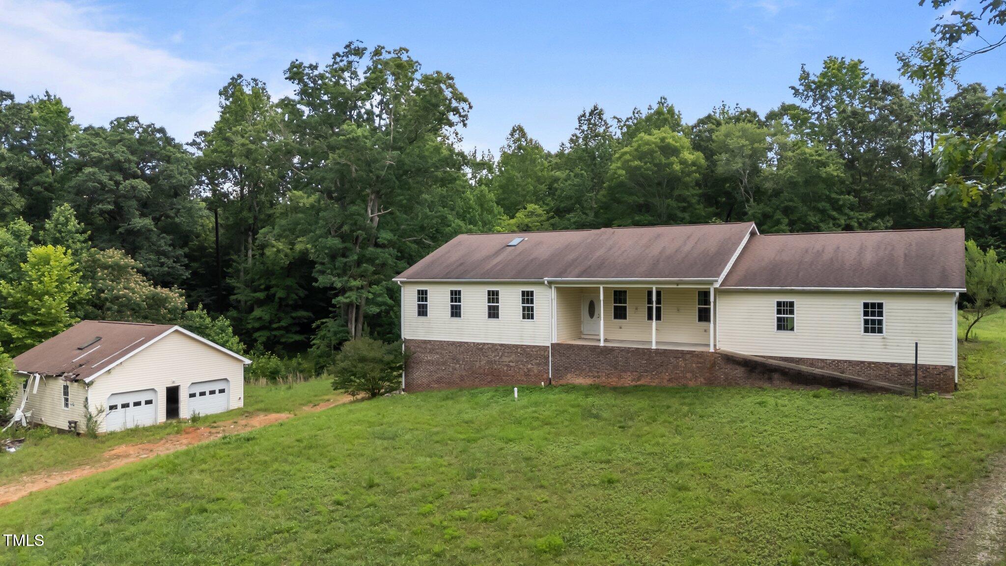 129 Shaman Drive Spring Hope, NC 27882 - Photo 3 of 33 a view of a house with a big yard and large trees