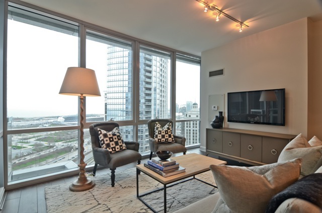 1201 South Prairie Avenue, Unit 804 Chicago, IL 60605 - Photo 13 of 13 a living room with furniture and a flat screen tv