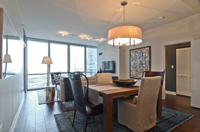 1201 South Prairie Avenue, Unit 804 Chicago, IL 60605 - Photo 5 of 13 a dining room with furniture window and wooden floor