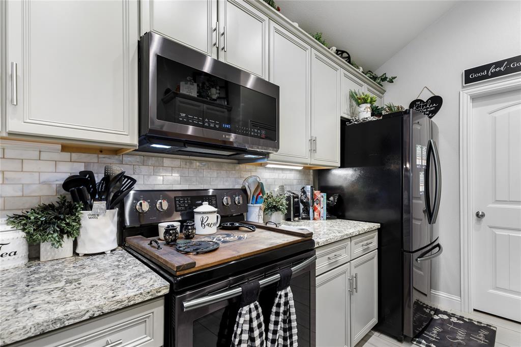 3016 Loy Lake Road Denison, TX 75020 - Photo 11 of 28 a kitchen with stainless steel appliances granite countertop a sink stove and refrigerator