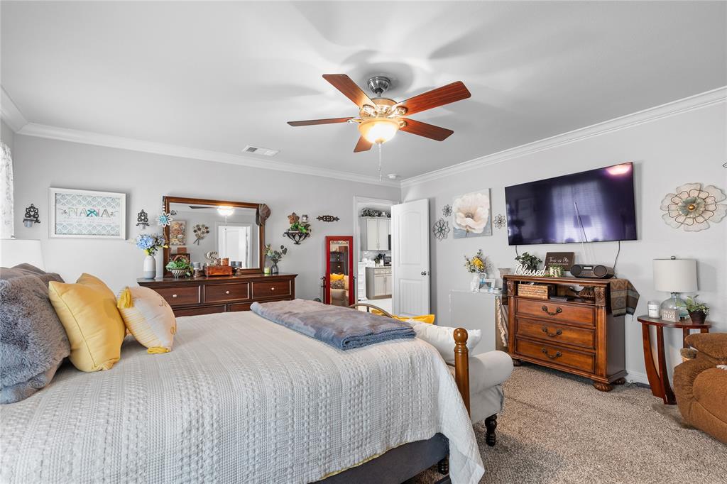 3016 Loy Lake Road Denison, TX 75020 - Photo 14 of 28 a bedroom with a bed and a chandelier